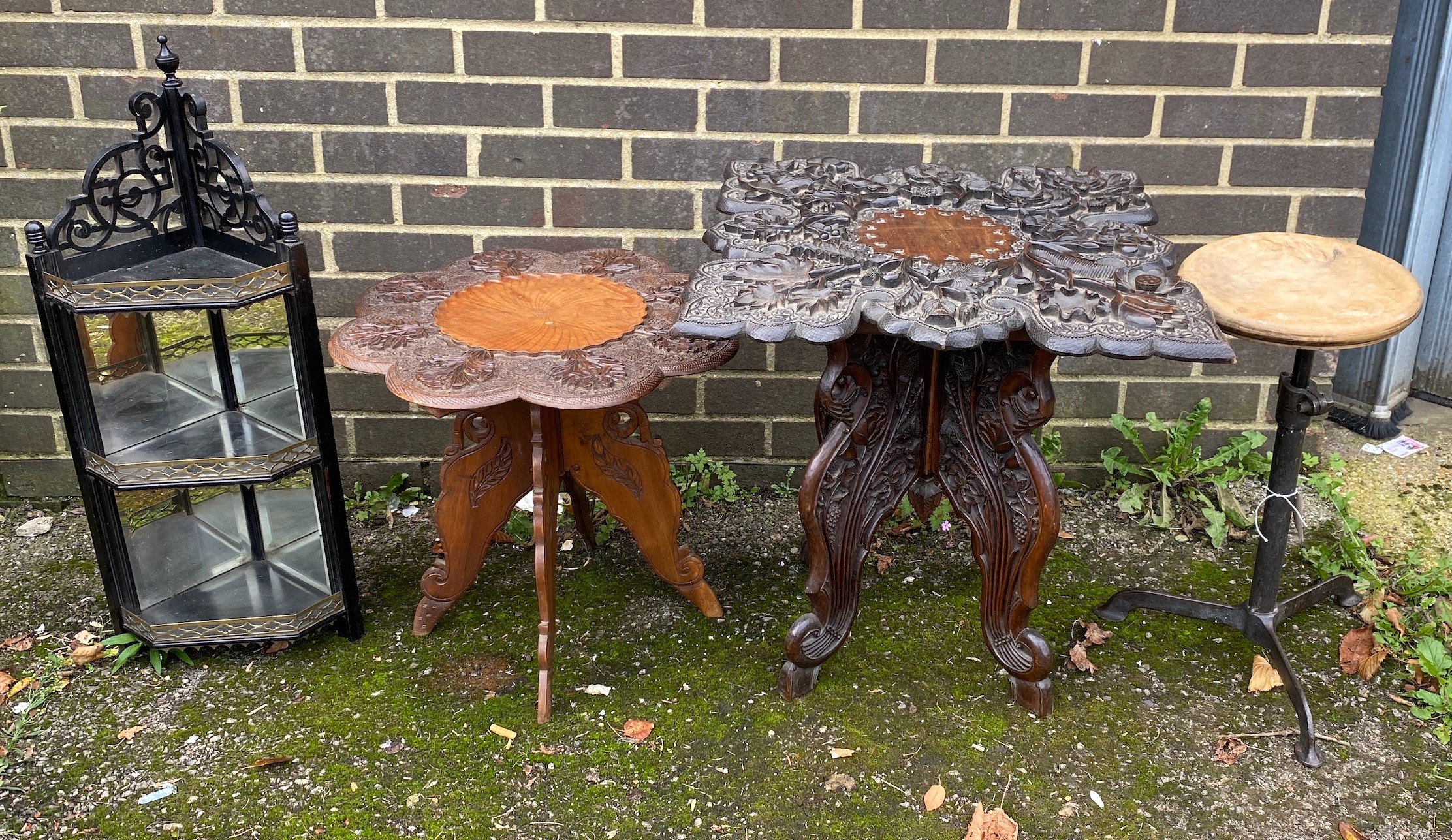 Two Indian carved hardwood occasional tables, a Victorian ebonised corner wall bracket and an industrial stool